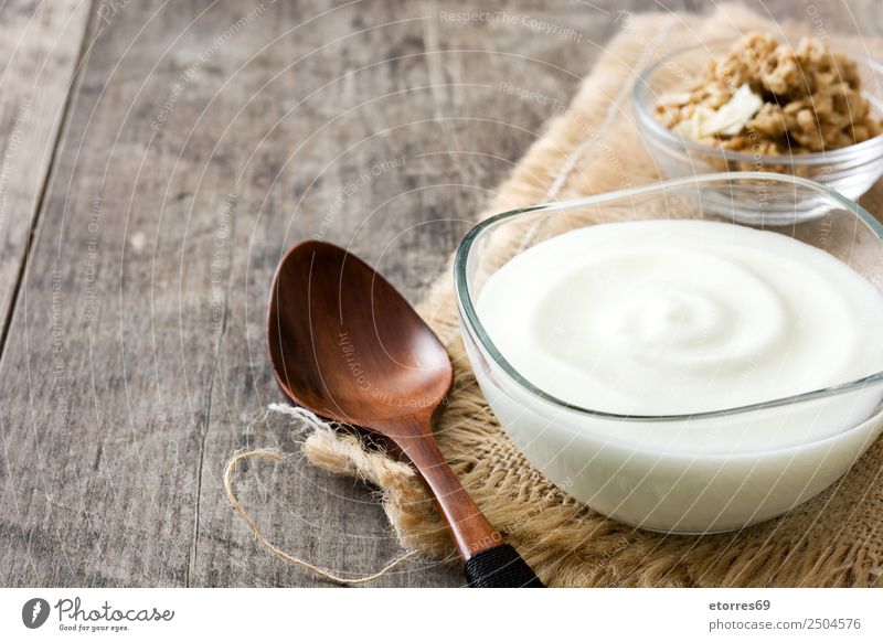 Greek yogurt in glass bowl on wooden table Food Yoghurt Dessert Candy Nutrition Breakfast Organic produce Bowl Wood Glass Natural White Food photograph