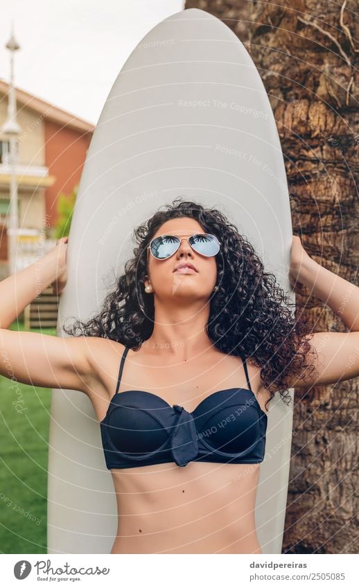 Brunette surfer woman in bikini standing with surfboard Lifestyle Joy Happy Beautiful Leisure and hobbies Vacation & Travel Summer Beach Ocean Garden Sports