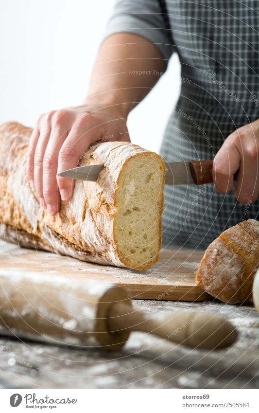 Woman cutting bread on wooden table Food Healthy Eating Food photograph Bread Breakfast Feminine Adults 1 Human being 30 - 45 years Work and employment Fresh