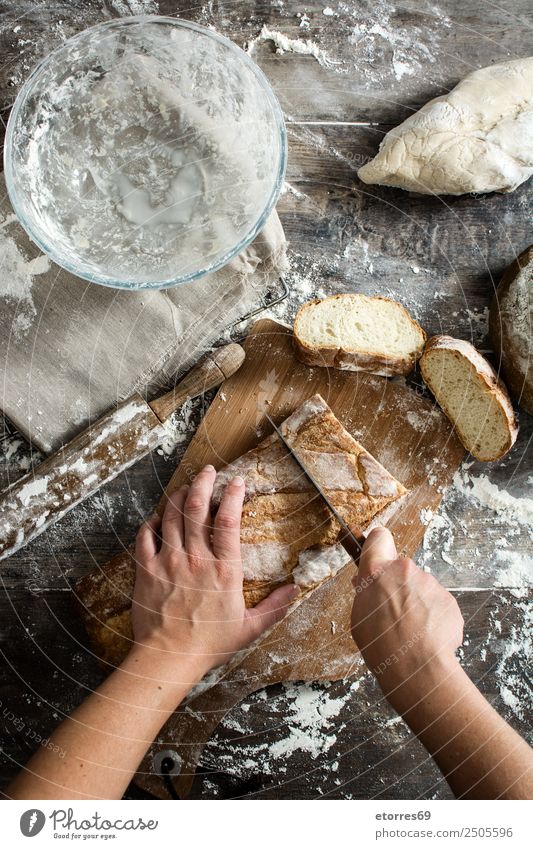 Woman cutting bread on wooden table Food Healthy Eating Food photograph Bread Breakfast Feminine Adults 1 Human being 30 - 45 years Work and employment Fresh