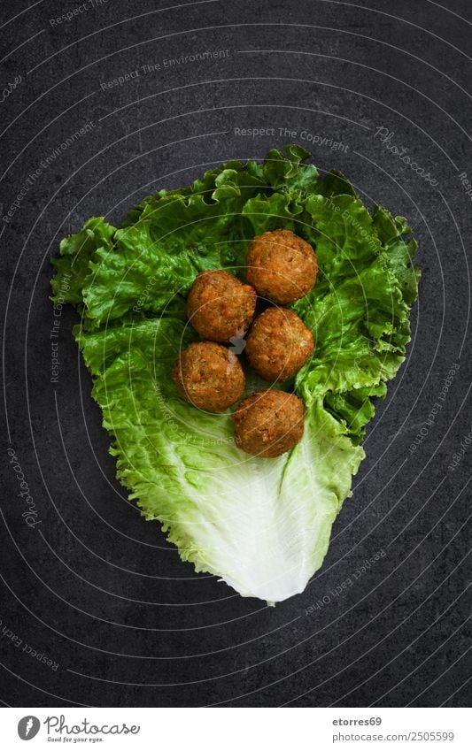 Falafel and lettuce on black background. Food Healthy Eating Food photograph Vegetable Grain Asian Food Bowl Fresh Brown falafel Chickpeas Lettuce hummus