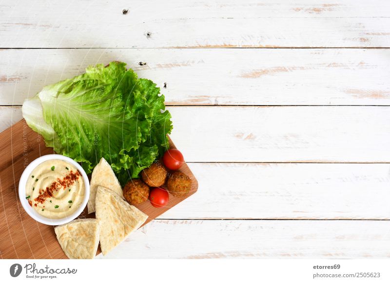 Falafel and vegetables on white wood Food Healthy Eating Dish Food photograph Vegetable Grain Asian Food Bowl Fresh Brown falafel Chickpeas Tomato Lettuce