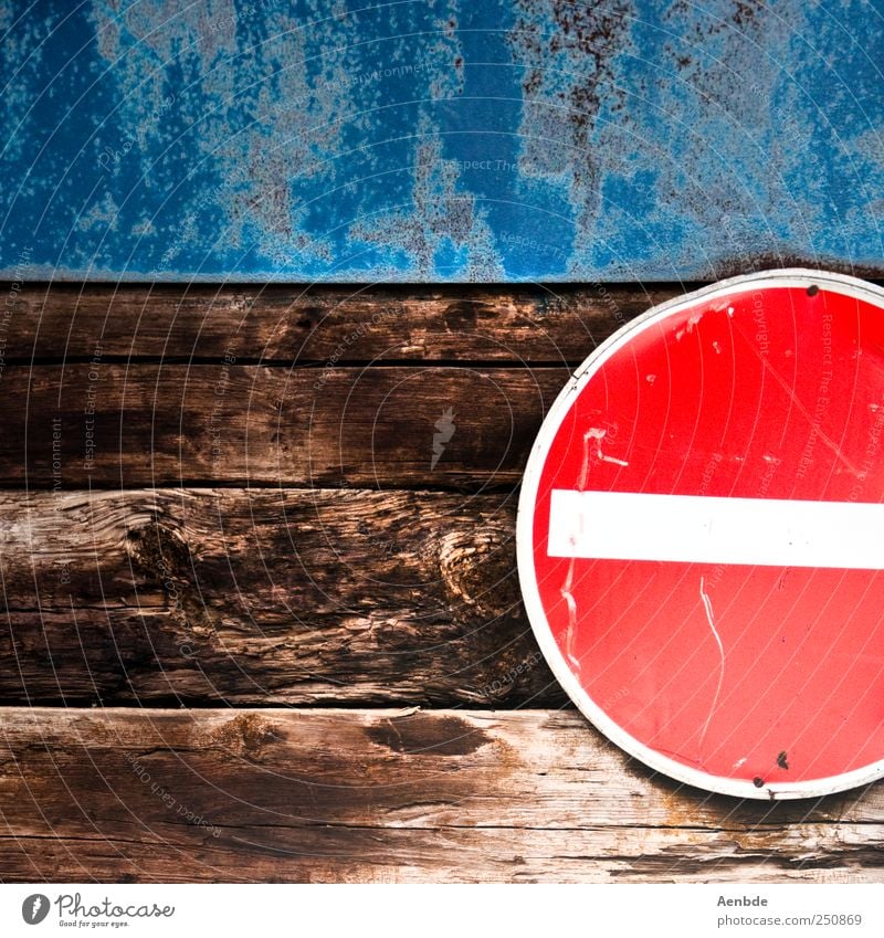 No getting through Road sign Simple Passage One-way street Red Blue Brown Wall (building) Wood Roof beams Colour photo Exterior shot Abstract Deserted