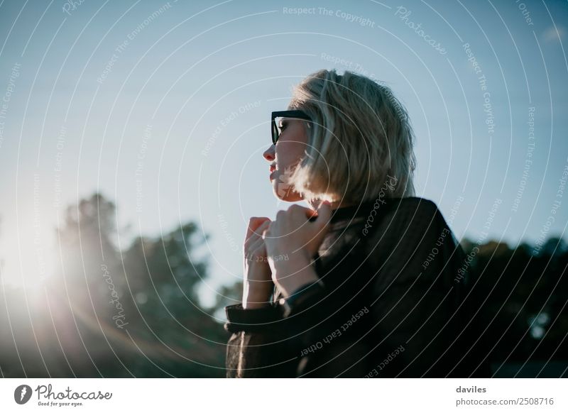 Blonde girl with sunglasses posing at sunset on her side Lifestyle Elegant Style Beautiful Harmonious Well-being Leisure and hobbies Sun Human being Feminine