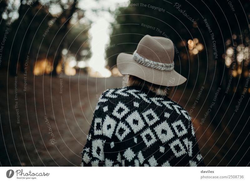 Woman with hat on her back walking by a path crossing the forest Lifestyle Vacation & Travel Tourism Trip Adventure Mountain Hiking Human being Feminine Adults