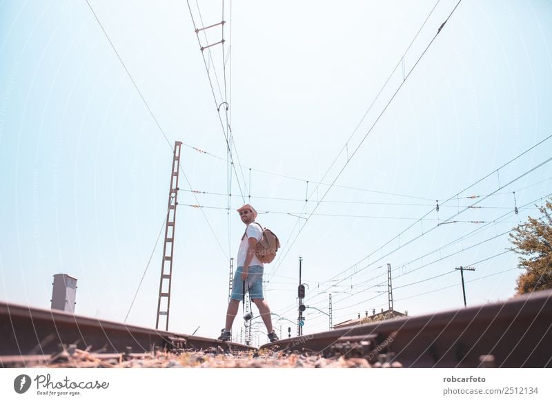 man walking by train Beautiful Vacation & Travel Trip Business Human being Man Adults Grass Transport Street Railroad Line Modern Blue Green Black White