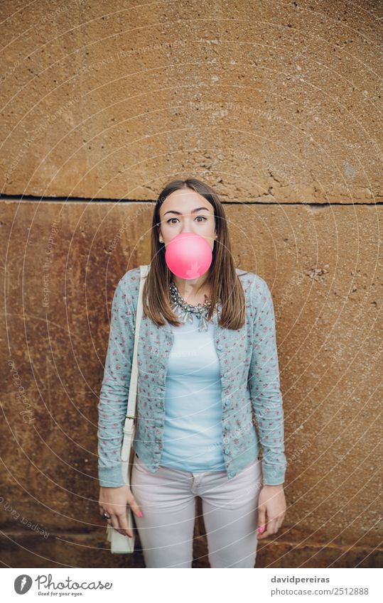 Young teenage girl blowing pink bubble gum Lifestyle Joy Happy Beautiful Face Human being Woman Adults Youth (Young adults) Mouth Lips Fashion Brunette Balloon