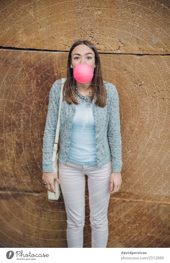 Young teenage girl blowing pink bubble gum Lifestyle Joy Happy Beautiful Face Human being Woman Adults Youth (Young adults) Mouth Lips Fashion Brunette Balloon