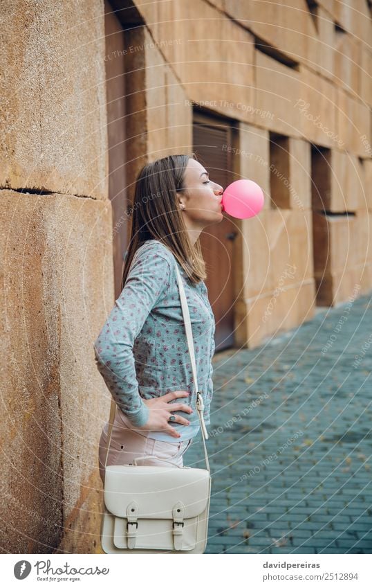 Young teenage girl blowing pink bubble gum Lifestyle Joy Happy Beautiful Face Human being Woman Adults Youth (Young adults) Mouth Lips Fashion Brunette Balloon