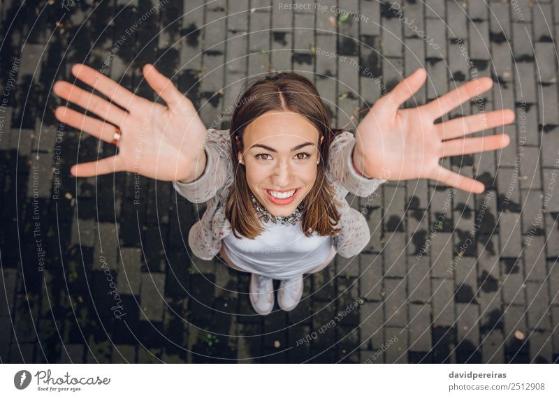 Happy young woman raising her hands up outdoors Lifestyle Joy Beautiful Leisure and hobbies Freedom Success Human being Woman Adults Arm Hand Street Fashion