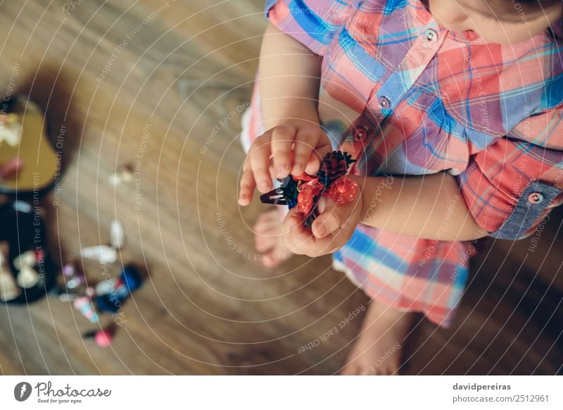 Baby girl playing with hair clips in the hands Lifestyle Joy Happy Beautiful Playing House (Residential Structure) Child Human being Woman Adults Infancy Hand