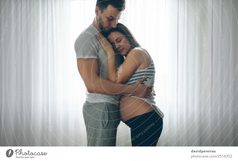 Pregnant woman embraced by her husband Lifestyle Beautiful Human being Baby Woman Adults Man Parents Mother Father Family & Relations Couple Partner Love