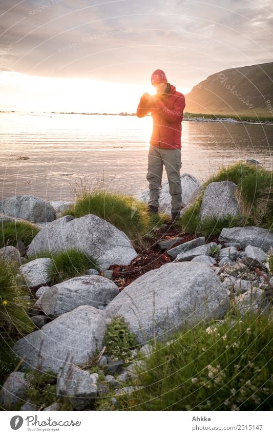 Young man in midnight sun Harmonious Relaxation Calm Trip Adventure Far-off places Freedom Youth (Young adults) Life Landscape Rock Coast Ocean Discover