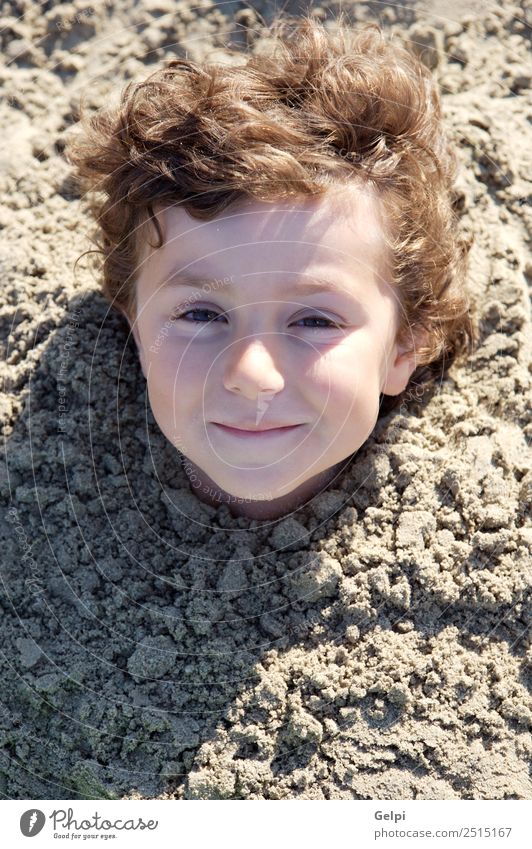 Small child buried in the sand of the beach Joy Happy Face Playing Vacation & Travel Summer Sun Beach Ocean Sports Child School Human being Boy (child) Man