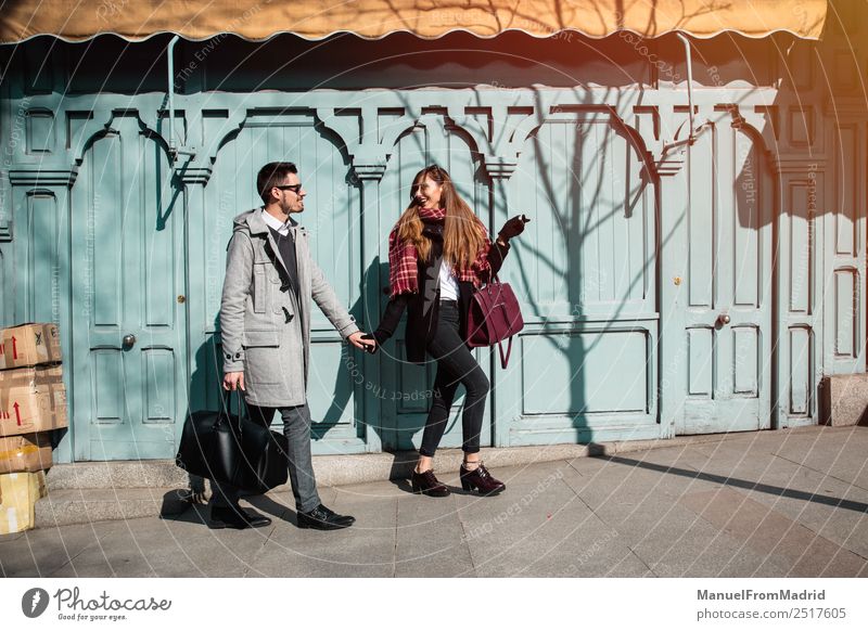 Couple of tourists walking down the street Lifestyle Elegant Style Joy Happy Beautiful Vacation & Travel Tourism Sightseeing Winter Human being Woman Adults