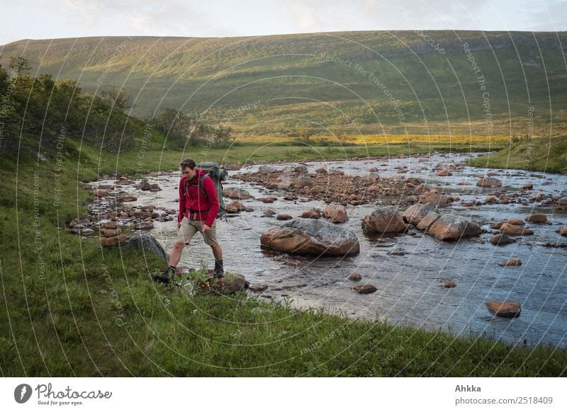 Young man with rucksack crosses a rocky river Vacation & Travel Adventure Freedom Hiking Education Adult Education Academic studies Youth (Young adults) Nature