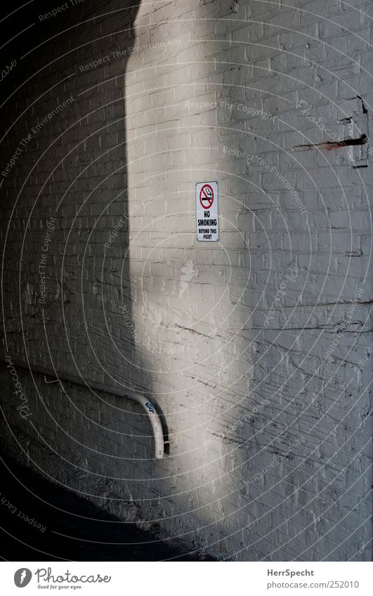 "No smoking beyond this point" Manmade structures Building Wall (barrier) Wall (building) Sign Signs and labeling Signage Warning sign Gray White