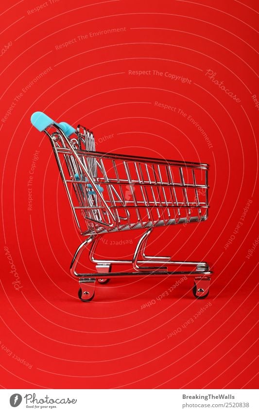 Empty toy supermarket shopping cart over red background Toys Metal Small Red Shopping Shopping Trolley Shopping basket Cart Retail sector Consumption Profile