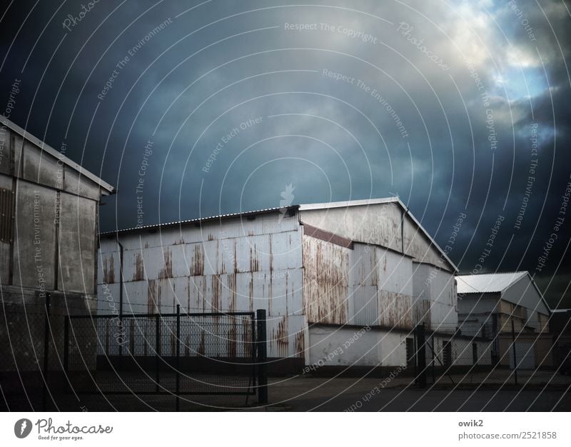 deposit Sky Clouds Corrugated iron wall Warehouse Metal Old Threat Dark Colour photo Subdued colour Exterior shot Deserted Copy Space left Copy Space right