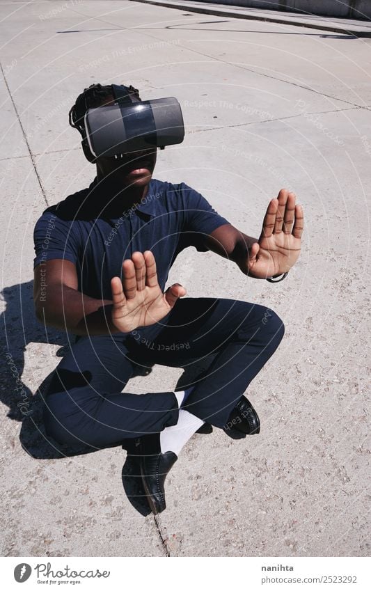 Young gamer man wearing a headset of virtual reality Lifestyle Leisure and hobbies Playing Computer games Sun Headset Games console Hardware Technology