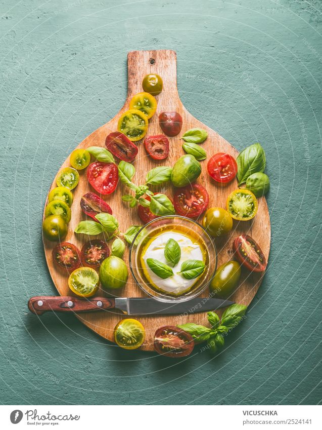 Colorful tomatoes with mozzarella and knife on cutting board Food Cheese Vegetable Nutrition Lunch Organic produce Vegetarian diet Diet Italian Food Bowl Knives