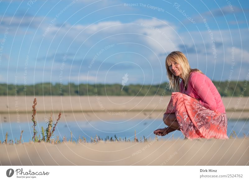 Woman squats on the beach and looks into the camera Vacation & Travel Tourism Summer Summer vacation Beach Ocean Human being Feminine Adults Mother Life 1