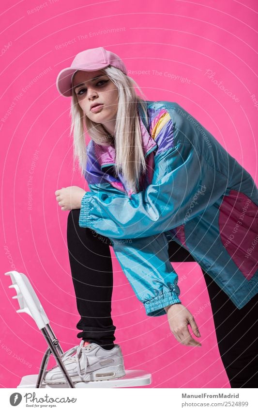 Stylish young woman posing Lifestyle Style Beautiful Make-up Chair Woman Adults Fashion Clothing Retro Crazy Cool (slang) 80s pink background swag Lean teenager