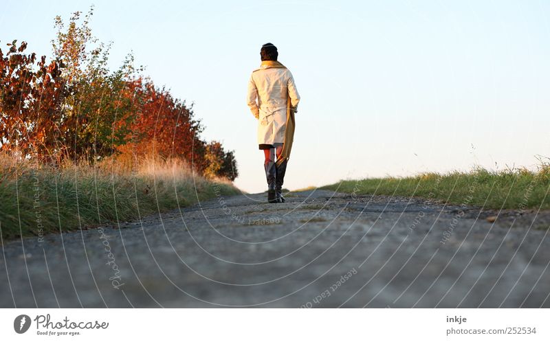 Autumn walk II Lifestyle Well-being Leisure and hobbies To go for a walk Freedom Human being Adults 1 Bushes Field Footpath Coat Scarf Boots Relaxation Going