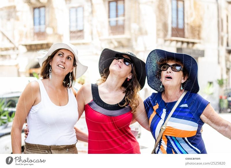 Three women looking up on the street Joy Happy Garden Human being Woman Adults Mother Grandmother Family & Relations Friendship Youth (Young adults) Group