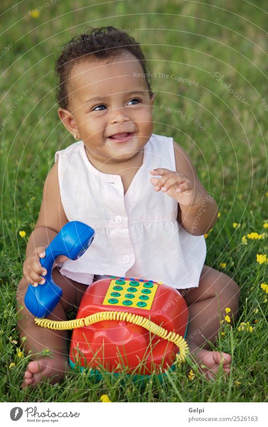 Adorable little black girl with big phone Herbs and spices Beautiful Playing Freedom Garden Child Telephone Baby Toddler Environment Nature Flower Grass Meadow