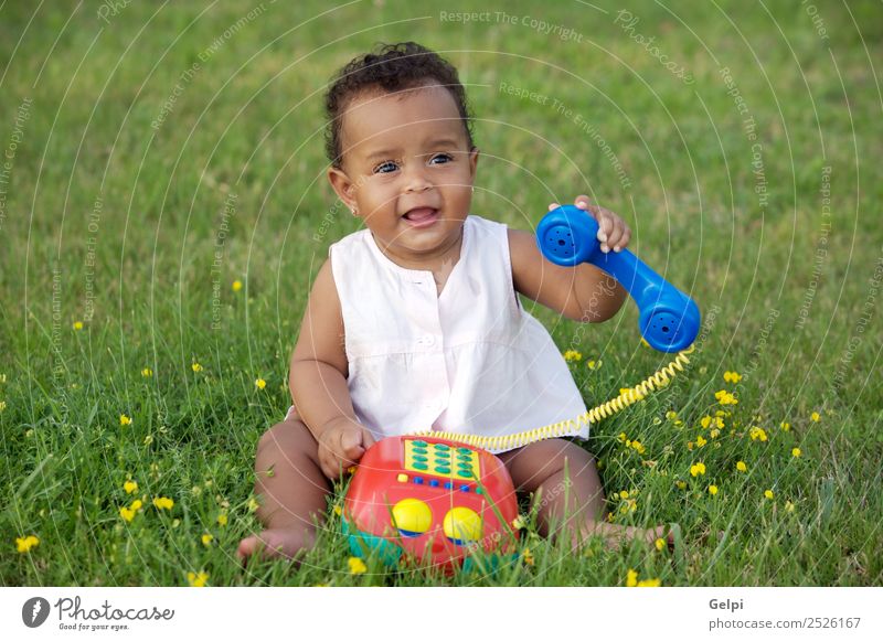 Adorable little black girl with big phone Herbs and spices Beautiful Playing Freedom Garden Child Telephone Baby Toddler Environment Nature Flower Grass Meadow