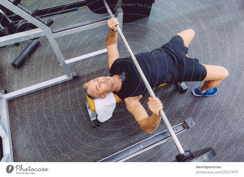 Man doing exercises with barbell on a bench press training in a fitness center Lifestyle Body Sports Work and employment Human being Adults Arm Fitness