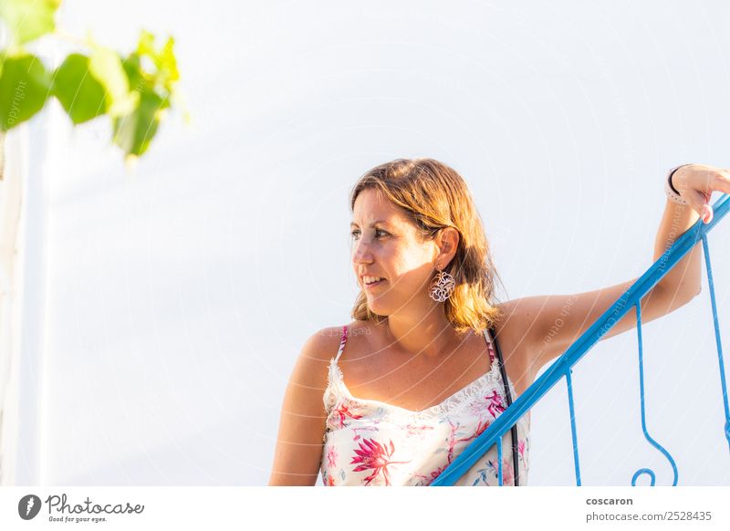 Middle aged woman leaning on a blue railing in a greek village. Style Beautiful Hair and hairstyles Vacation & Travel Tourism Trip Summer Ocean Human being