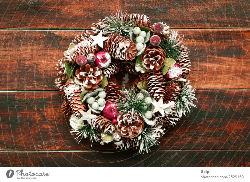 Delicate Christmas wreath of pine cones on wooden background Fruit Apple Beautiful Winter Snow Decoration Feasts & Celebrations Christmas & Advent Ornament