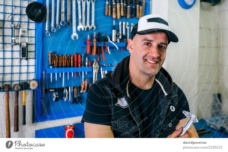 Mechanic posing with a motorcycle Lifestyle Style Happy Work and employment Engines Human being Man Adults Vehicle Motorcycle Smiling Authentic Retro Black