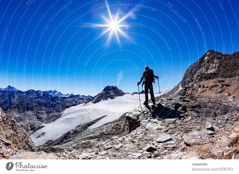 Hiker reaches a high mountain pass, Italian Alps Vacation & Travel Adventure Expedition Summer Sun Mountain Hiking Sports Success Man Adults Nature Landscape