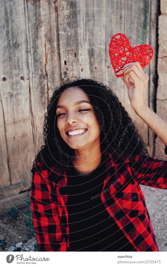 Cheerful young woman holding a red heart Lifestyle Style Design Joy Beautiful Healthy Wellness Well-being Contentment Human being Feminine Young woman