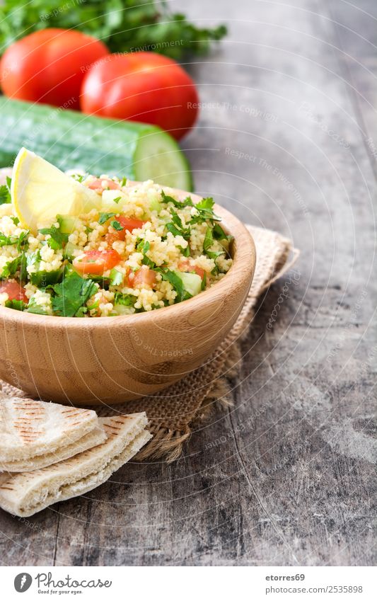 Tabbouleh salad and ingredients on wood Table Salad couscous Vegetable Tomato Cucumber Parsley Mint Vegan diet Vegetarian diet Healthy Eating Nutrition Diet