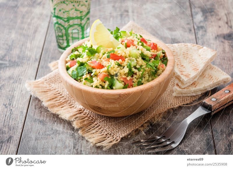 Tabbouleh salad and ingredients on wood Table Salad couscous Vegetable Tomato Cucumber Parsley Mint Vegan diet Vegetarian diet Healthy Eating Nutrition Diet