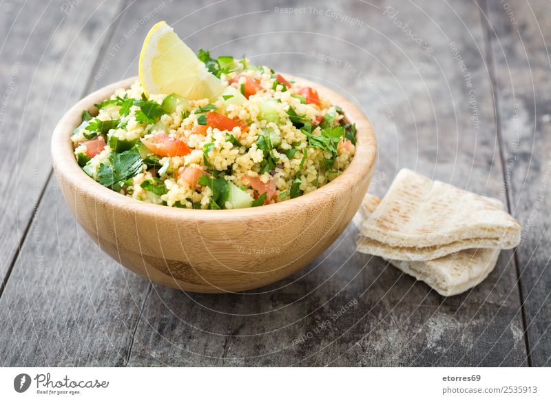 Tabbouleh salad and ingredients on wood Table Salad couscous Vegetable Tomato Cucumber Parsley Mint Vegan diet Vegetarian diet Healthy Eating Nutrition Diet