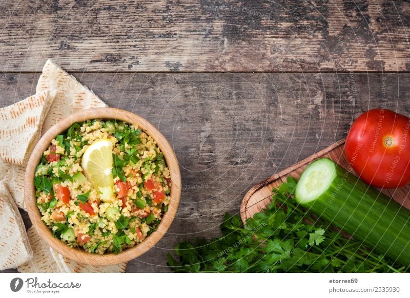 Tabbouleh salad with couscous on a wood Table Salad Vegetable Tomato Cucumber Parsley Mint Vegan diet Vegetarian diet Healthy Healthy Eating Nutrition Diet Bowl