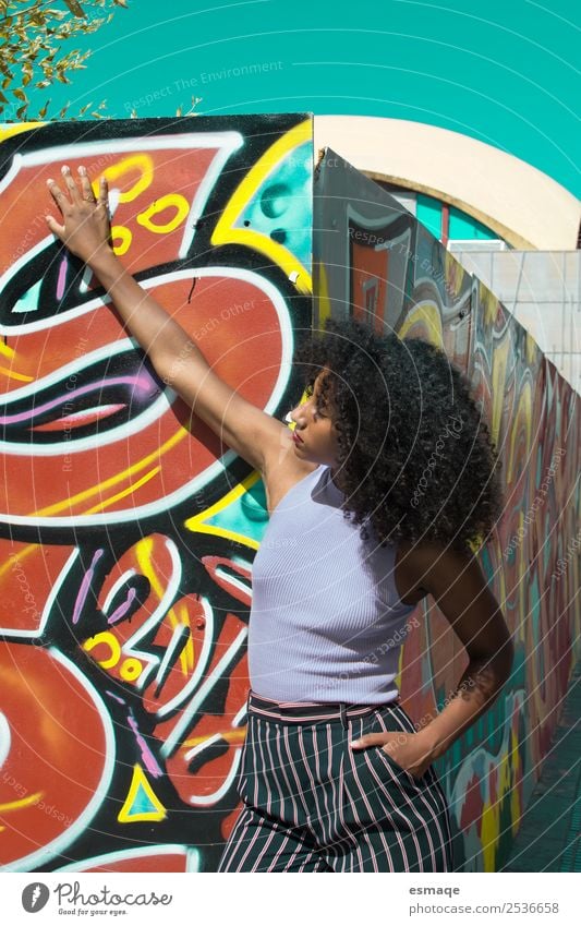 Portrait of urban woman with graffiti Lifestyle Exotic Joy Beautiful Feminine Young woman Youth (Young adults) Fashion Afro Graffiti Adventure Emotions Serene