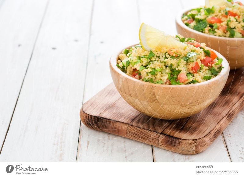 Tabbouleh salad with couscous on a white table Table Salad Vegetable Tomato Cucumber Parsley Mint Vegan diet Vegetarian diet Healthy Healthy Eating Nutrition