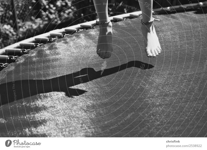 Girl on trampoline bk Garden Sports Trampoline Human being Child Feet 1 Jump Gray Joy Shadow garden trampoline Salto Black & white photo Exterior shot Day