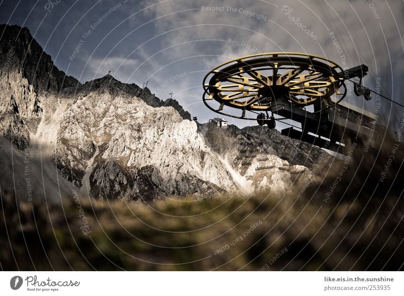 summer sleep Environment Nature Clouds Sunlight Summer Grass Alps Mountain Peak Gloomy Deserted Ski lift Wheel Summer vacation time Austria Colour photo