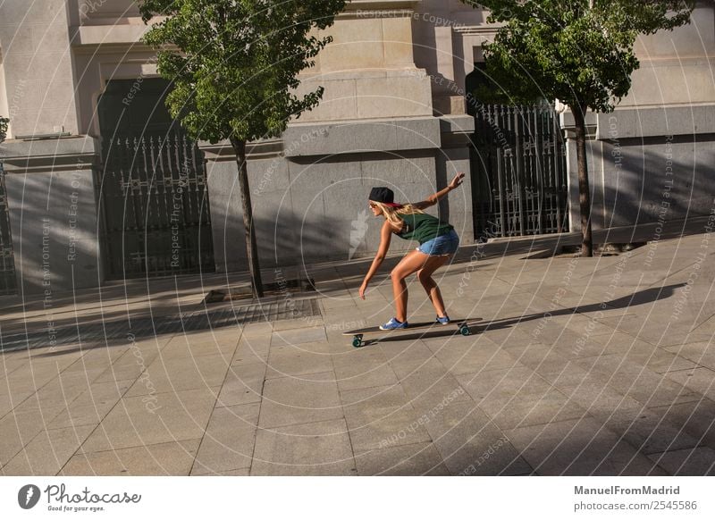 young woman skating in the street Lifestyle Style Joy Beautiful Leisure and hobbies Summer Woman Adults Downtown Street Sunglasses Blonde Movement Smiling