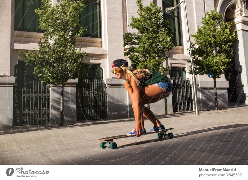 young woman skating in the street Lifestyle Style Joy Beautiful Leisure and hobbies Summer Woman Adults Downtown Street Sunglasses Blonde Movement Smiling