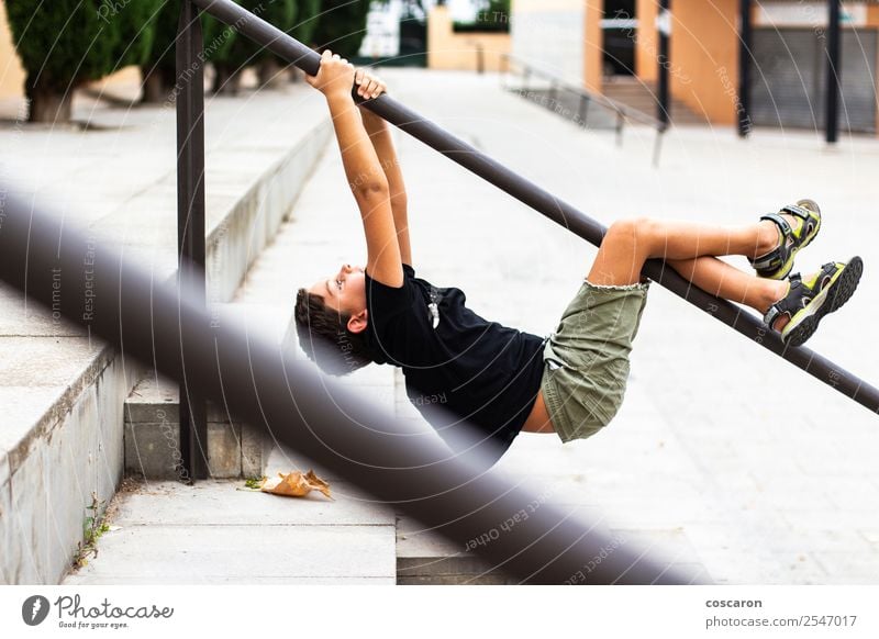 Brave child hanging from a park bar Lifestyle Joy Happy Healthy Wellness Leisure and hobbies Playing Summer Sports Climbing Mountaineering Sportsperson Child