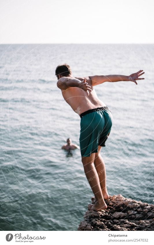 Man preparing to jump into sea Human being Adults 1 Environment Nature Earth Air Sun Solar eclipse Sunrise Sunset Summer Ocean Water To swing Swimming & Bathing