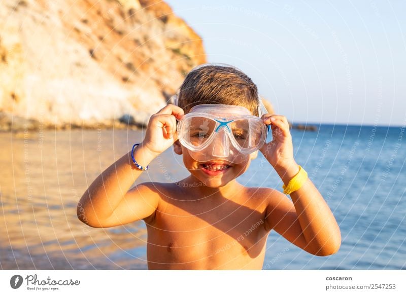 Kid with diving goggles on the shore of the ocean Lifestyle Joy Happy Relaxation Swimming pool Leisure and hobbies Vacation & Travel Summer Beach Ocean Sports